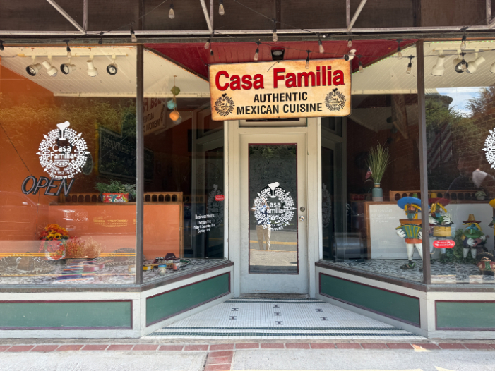 Casa Familia storefront in Bramwell, with large display windows, decorative figures, and a sign reading 'Authentic Mexican Cuisine'