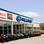 Swamp Fox Motorsports building with brand signs and rows of ATVs lined up outside.