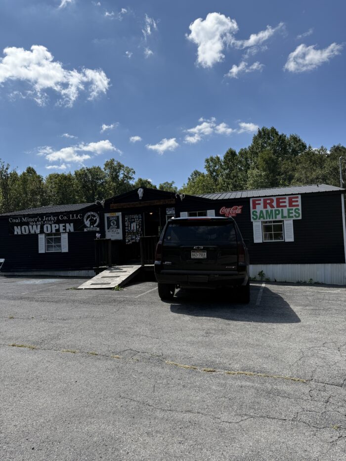 Coal Miner’s Jerky Co. storefront in Princeton, West Virginia, with a large “Free Samples” sign outside on a sunny day.